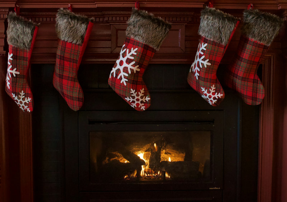 Red and white Christmas stocking hanging on a fireplace mantel, waiting for stocking stuffers for women