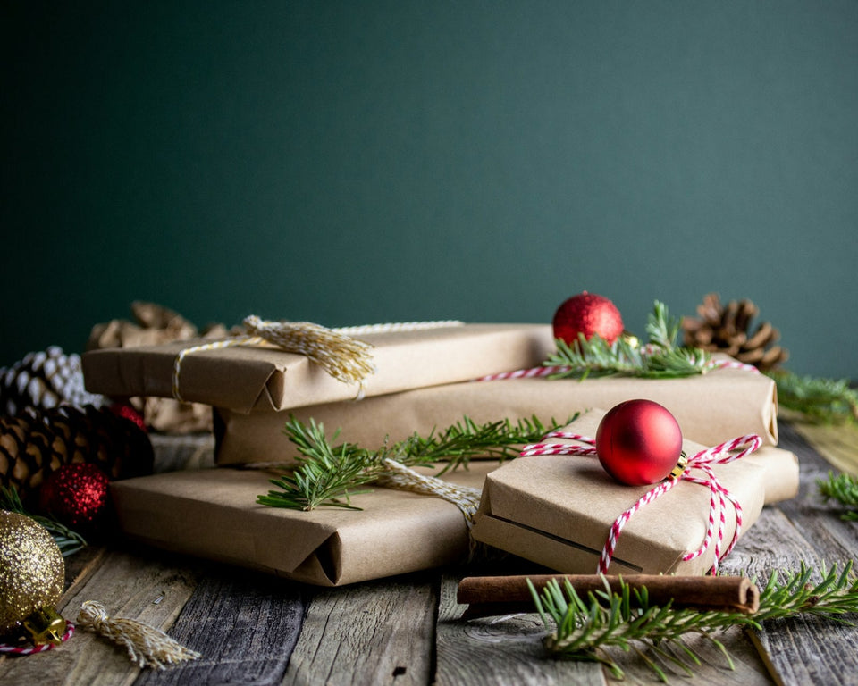 Wrapped personalized Christmas gifts stacked on a table, ready for gift giving