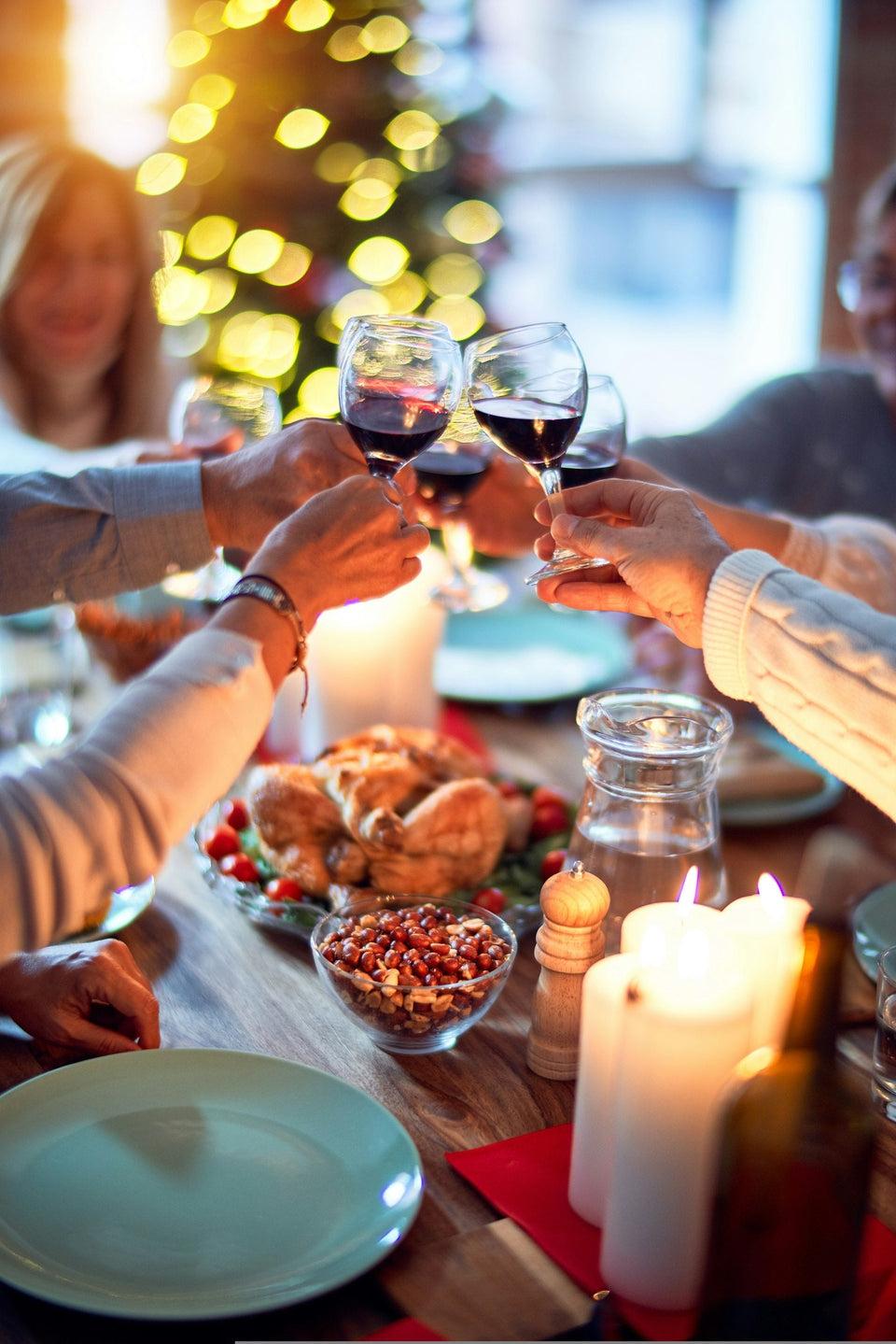 Friends toasting with red wine over a festive Thanksgiving dinner table, a perfect moment for hostess Thanksgiving gifts