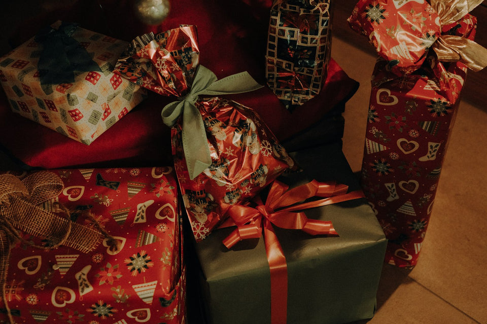 Pile of wrapped Christmas presents ready for a Secret Santa gift exchange